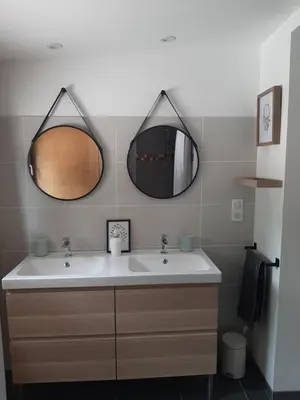 a bathroom with a sink and two mirrors at La Colinière, Chambre d'hôtes in Aix-en-Provence