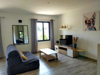 a living room with a couch and a tv at Lou Mazet provençal à Eygalières - Piscine privée in Eygalières