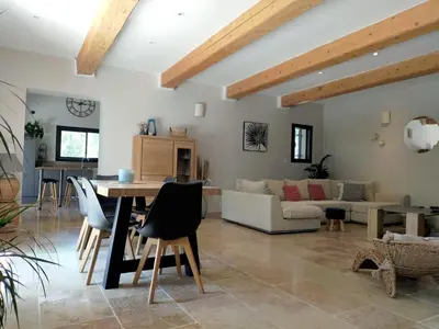 a living room with a table and a couch at Lou Mazet provençal à Eygalières - Piscine privée in Eygalières