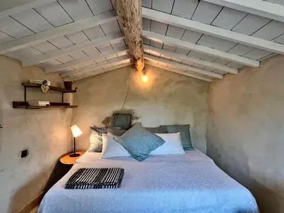 a bedroom with a bed in a small room at Cabanon bucolique face au Luberon in Lourmarin