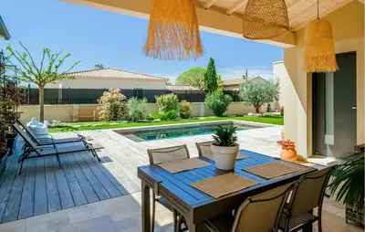 a patio with a table and chairs and a pool at Amazing Home In Robion in Robion en Luberon