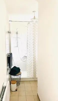 a bathroom with a shower with a shower curtain at Maison LINA in Sault-de-Vaucluse