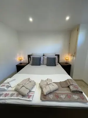 a bedroom with a large bed with two pillows on it at Gîte l’Inattendu in Vachères
