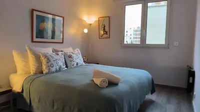 a bedroom with a bed with a hat on it at Appartement Port Royal in Aix-en-Provence