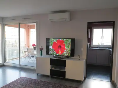 a living room with a flat screen tv on a table at Appartement Port Royal in Aix-en-Provence