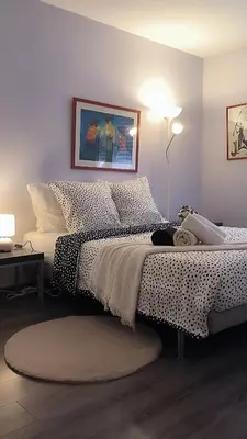a bedroom with a bed with polka dot sheets at Appartement Port Royal in Aix-en-Provence