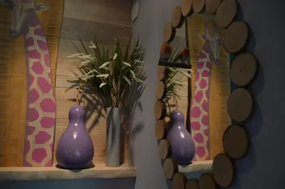 two purple vases sitting on a shelf next to a window at Le gîte du petit branché in Mazan
