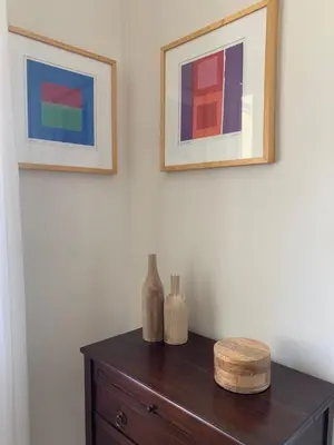 a table with two pictures and two vases on it at Le Domaine de l'Aiguille Alpilles, Eygalières, Saint Rémy de Provence in Orgon