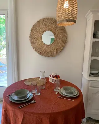 a table with plates and glasses and a mirror at Le Domaine de l'Aiguille Alpilles, Eygalières, Saint Rémy de Provence in Orgon