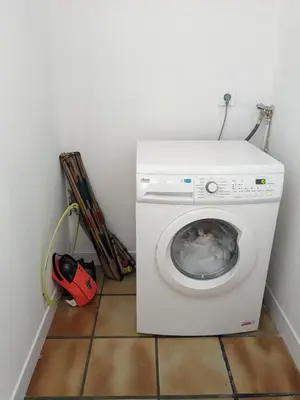 a white washing machine in a room with at La ferme du TourreBlanc in Lambesc
