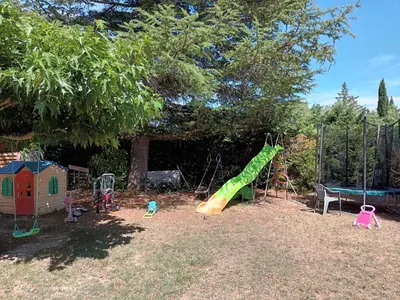 a playground with a slide and play equipment at Chambre raisin 2p, pour 2 nuits max, a 6km du festival de piano de la roque d'anthéron à 100m de la piscine in Rognes