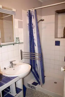 a bathroom with a sink and a shower curtain at Maison accueillante à Reillanne avec jardin clos in Reillanne