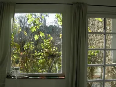 a window in a room looking out at a tree at Maison accueillante à Reillanne avec jardin clos in Reillanne