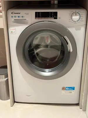 a white washing machine sitting in a kitchen at Appartement exceptionnel avec parking Centre-ville Aix-en-Provence in Aix-en-Provence