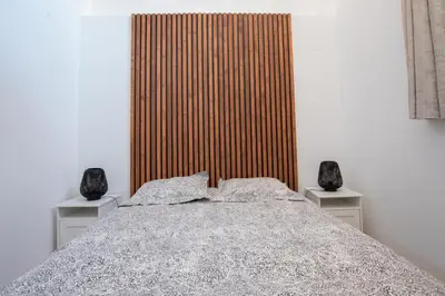a bedroom with a large bed with two night stands at Au NÈGO CHIN 105m2 en bord de Sorgue in LʼIsle-sur-la-Sorgue