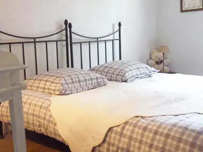 a bed with two pillows and a teddy bear at La Tour D'Orgueil in Mallemort