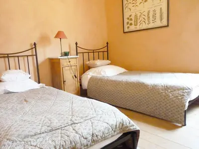a bedroom with two beds and a dresser in it at La Tour D'Orgueil in Mallemort
