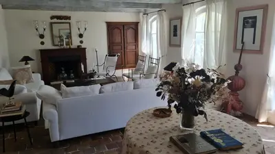 a living room with a white couch and a table at La Tour D'Orgueil in Mallemort