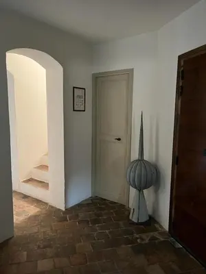 a hallway with a white door and a stair case at La Tour D'Orgueil in Mallemort