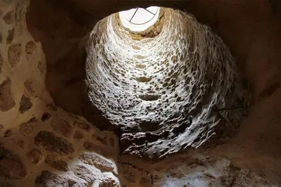 a cave with a hole in the floor with a window at La Maison d'en Bas des Seigneurs in Cucuron