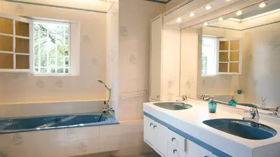 a bathroom with two sinks and a large mirror at Villa Bois Romay dans le Luberon avec piscine, tennis et pétanque. in La Bastide-des-Jourdans