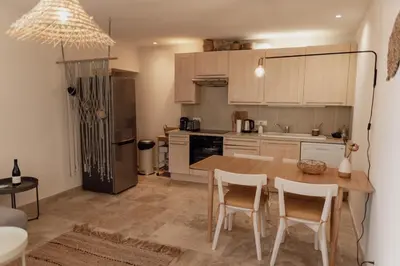 a kitchen with a table and chairs in a room at GITE LE TILLEUL in Mormoiron