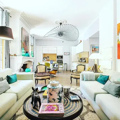 a living room with two couches and a table at Cosy Loft tarif avec 1 ou 2 chambres 2 ou 4 personnes, vue parc et piscine in Aix-en-Provence