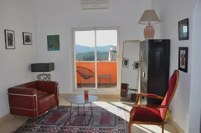 a living room with a couch and a table at Les Moineaux in Rustrel