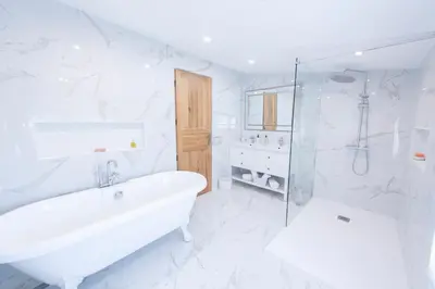 a bedroom with a large bed and a couch at La Bastide des Lavandins in Le Thor