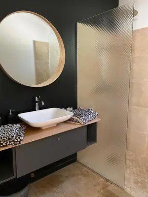 a bathroom with a sink and a mirror at Maison dans la pinède in Rognes