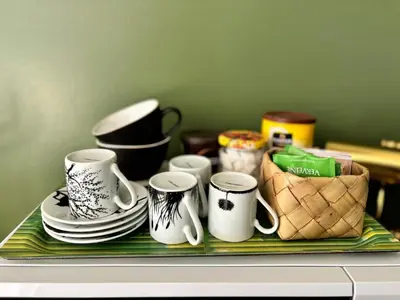 a tray with mugs and plates on a table at Maison dans la pinède in Rognes