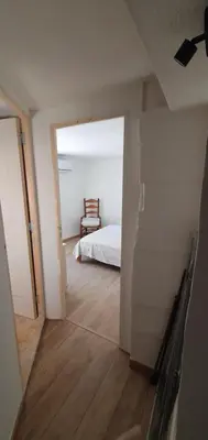 a room with a bedroom with a bed and a chair at La Carriera, petite maison Provençale sud Ventoux, climatisée in Bédoin