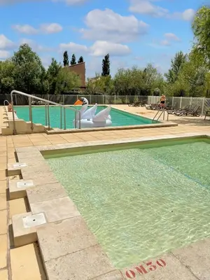 a swimming pool with a slide in the middle at Maison confortable Saint-Saturnin in Saint-Saturnin-lès-Avignon