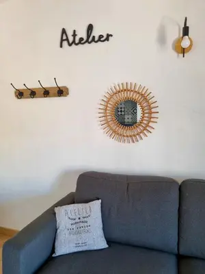 a living room with a couch and a mirror on the wall at Un balcon sur les toits d'Aix in Aix-en-Provence