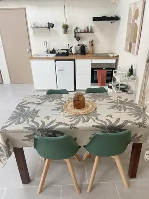 a kitchen with a table and chairs with a table and a kitchen at Bonnieux : Loft - La pause in Bonnieux