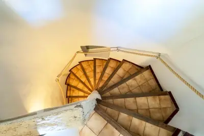 a view of a spiral staircase in a building at Appartement à L'Isle-sur-la-Sorgue avec vue sur la ville in LʼIsle-sur-la-Sorgue