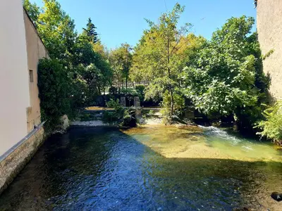 an aerial view of a river near a building at Appartement à L'Isle-sur-la-Sorgue avec vue sur la ville in LʼIsle-sur-la-Sorgue