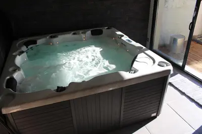 a bath tub filled with water in a room at Maison avec piscine, jacuzzi et sauna privatifs - Mas de Nebbas in Aix-en-Provence