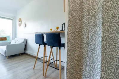 a kitchen with two blue bar stools in a room at Studio cosy à proximité du centre ville in Aix-en-Provence