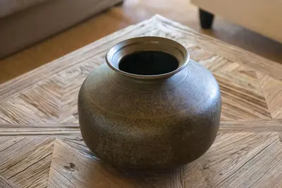 a brown vase sitting on a wooden table at Mas De Rosemarie in Joucas