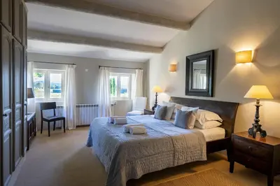 a bedroom with a bed and a desk and a chair at Mas De Rosemarie in Joucas