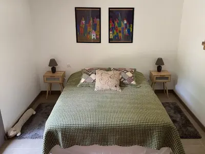 a bedroom with a bed and two night stands at Les Chêneslierres in Lourmarin