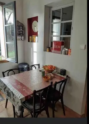 a dining room table with chairs and a table and a table and chairsktop at Le Jardin sur la colline près du Golf in LʼIsle-sur-la-Sorgue
