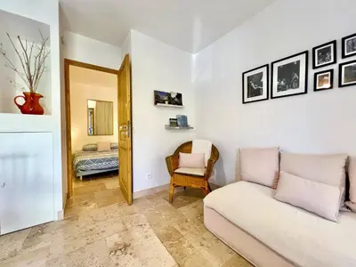 a living room with a couch and a chair at Lou Maestoso - Cosy, Campagne, CLIM, 2 personnes in Lançon-Provence