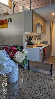 a vase of flowers sitting on a table in a kitchen at Adorable petite maison au coeur du Luberon in Villelaure