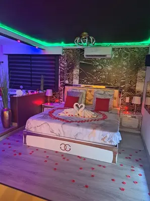 a bedroom with a large bed with roses on it at L'Aurore Love Room de prestige jacuzzi sauna piscine chauffée cuisine in Carpentras