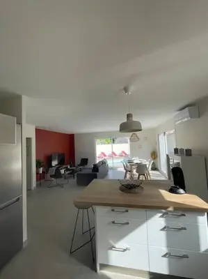 a kitchen with a counter top and a living room at Magnifique villa avec piscine extérieure in Alleins