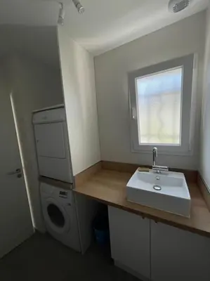 a bathroom with a sink and a washing machine at Magnifique villa avec piscine extérieure in Alleins