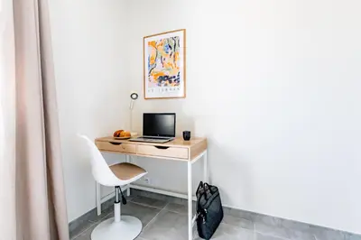 a desk with a laptop and a chair in a room at Havre de nature Provence in Morières-lès-Avignon