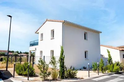 a white house with trees in front of it at Havre de nature Provence in Morières-lès-Avignon
